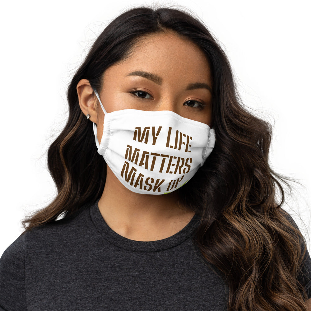 Woman in a white face mask with My Life Matters Mask Up with 333 Explosion logo
