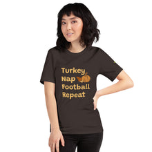 Load image into Gallery viewer, woman in a brown t-shirt with Turkey, nap, football, repeat also an image of 2 leaves and pumpkin. 333 Explosion logo on left sleeve.
